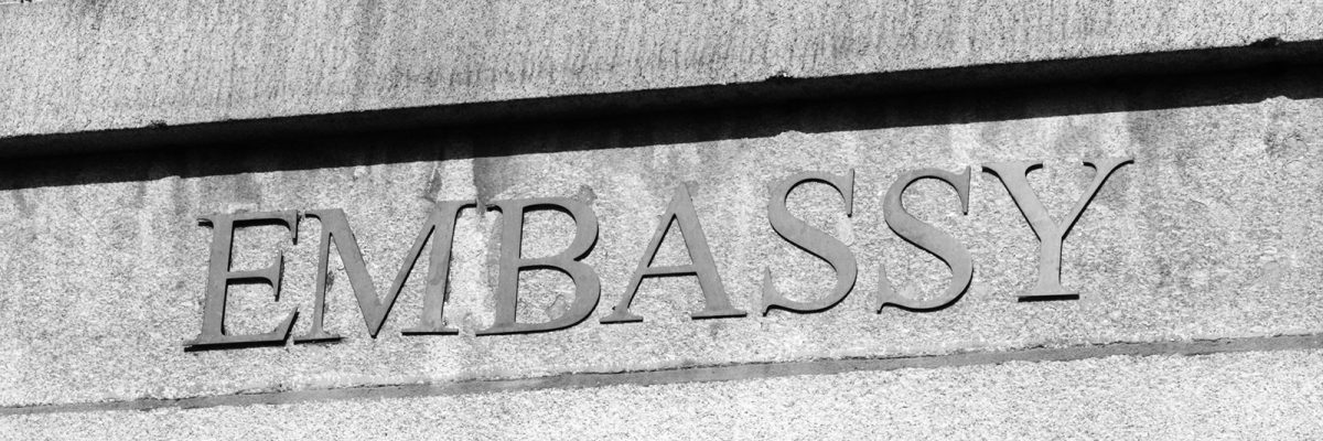 Embassy sign on a modern building entrance